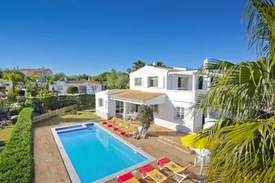 a villa with a swimming pool and a house at Villa Flor by Villa Plus in Guia