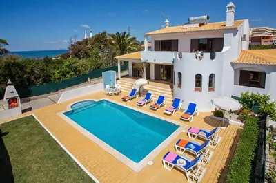 a villa with a swimming pool in front of a house at Villa Gregorio by Villa Plus in Galé