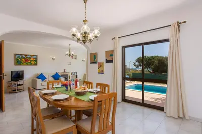 a dining room and living room with a table and chairs at Villa Gregorio by Villa Plus in Galé