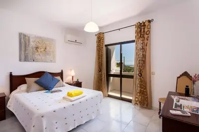 a bedroom with a bed and a large window at Villa Gregorio by Villa Plus in Galé
