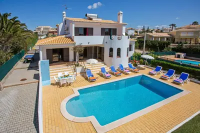 a villa with a swimming pool in front of a house at Villa Gregorio by Villa Plus in Galé