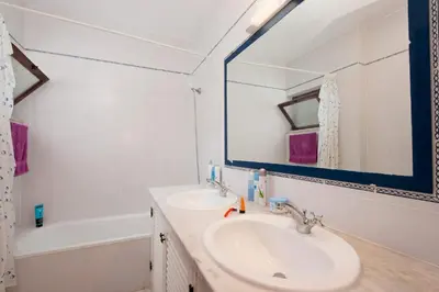 a bathroom with a sink and a mirror and a tub at Villa Medeira by Villa Plus in Albufeira