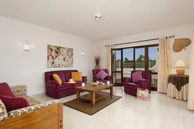 a living room with purple couches and a table at Villa Medeira by Villa Plus in Albufeira