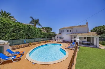 a swimming pool in the backyard of a house at Villa Praia by Villa Plus in Galé