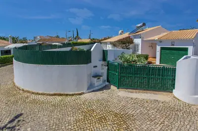 a house with a green fence and a gate at Villa Rocchi by Villa Plus in Albufeira