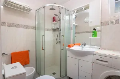 a bathroom with a shower and a toilet and a sink at Villa Rocchi by Villa Plus in Albufeira