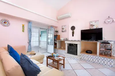 a living room with a couch and a fireplace at Villa Rocchi by Villa Plus in Albufeira