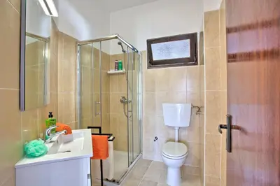 a bathroom with a toilet and a sink and a shower at Villa Vitor by Villa Plus in Albufeira