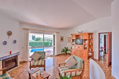 a living room with a fireplace and a tv at Villa Vitor by Villa Plus in Albufeira