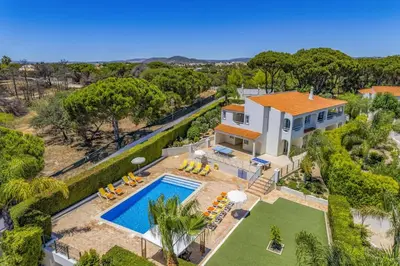 a room with two beds with white tablecloths at Villa Amora by Villa Plus in Vale do Lobo