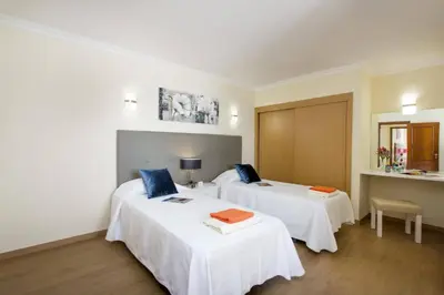 two beds in a room with white sheets at Villa Amora by Villa Plus in Vale do Lobo