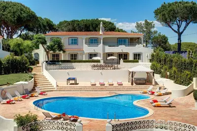 a large house with a swimming pool in front of it at Villa Beirais by Villa Plus in Vale do Lobo