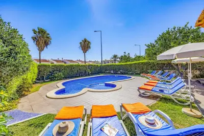 a group of chairs and a swimming pool at Villa Bolina by Villa Plus in Albufeira