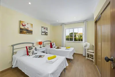 a room with two beds and a window at Villa Canas by Villa Plus in Vale do Lobo