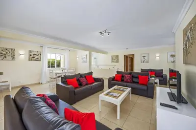 a large living room with couches and a table at Villa Canas by Villa Plus in Vale do Lobo