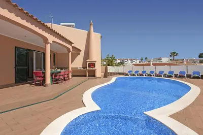 a villa with a swimming pool and a patio at Villa Siroco by Villa Plus in Albufeira