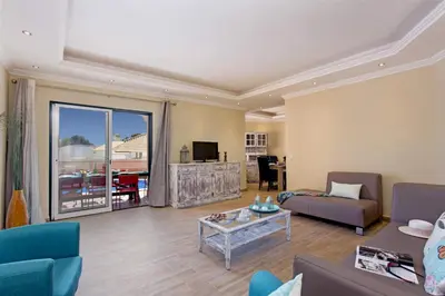 a living room with a couch and a table at Villa Siroco by Villa Plus in Albufeira