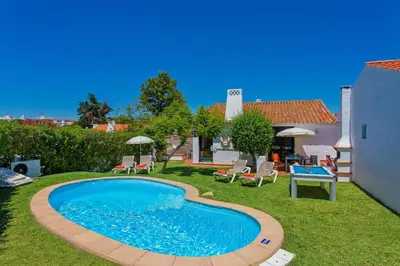 a swimming pool in the yard of a house at Villa Sueste by Villa Plus in Albufeira