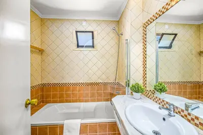 a bathroom with a tub and a sink at Villa Sueste by Villa Plus in Albufeira