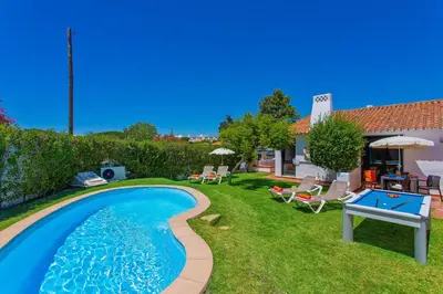 a swimming pool in the yard of a house at Villa Sueste by Villa Plus in Albufeira