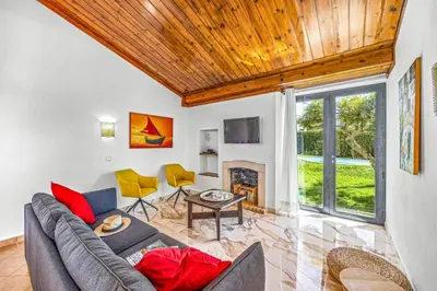 a living room with a couch and a fireplace at Villa Sueste by Villa Plus in Albufeira