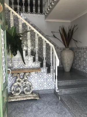 a staircase with a blue and white patterned wall at Palacete da Baixa by MY CHOICE in Faro