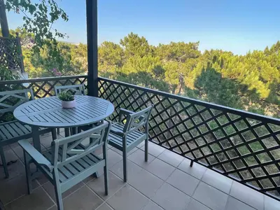 a table and chairs on a balcony with a view at Falesia Beach Apartment in Albufeira