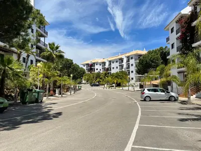 a street with a car parked on the side of the road at Falesia Beach Apartment in Albufeira
