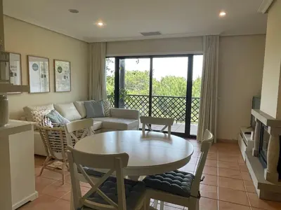 a living room with a table and a couch at Falesia Beach Apartment in Albufeira