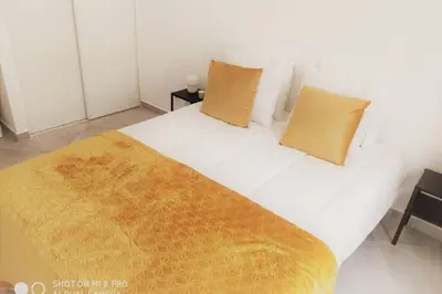 a bedroom with a large white bed with two pillows at Old Town House in Loulé