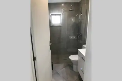 a bathroom with a toilet and a shower and a sink at Old Town House in Loulé
