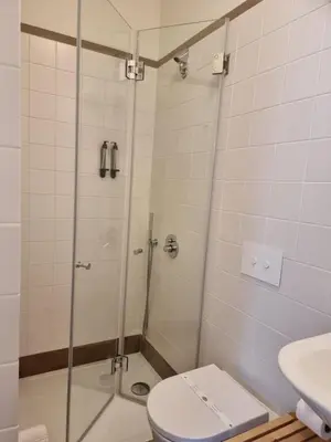 a bathroom with a shower with a toilet and a sink at Casa Algarbe in Faro