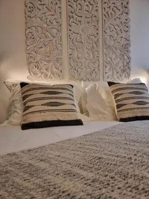 a white bed with two pillows and a headboard at Casa Algarbe in Faro