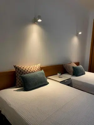 a room with two beds with pillows on them at Parra Holidays Q House in Guia