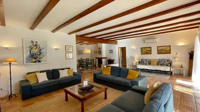 a living room with two blue couches and a table at Sol by Check-in Portugal in Vilamoura