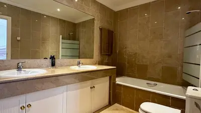 a bathroom with two sinks and a tub and a toilet at Ellegance by Check-in Portugal in Vilamoura