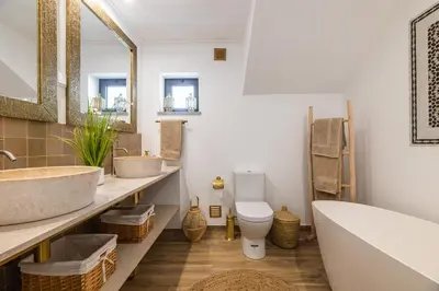 a bathroom with two sinks and a tub and a toilet at Riad Matias Galé - Luxury Villa with private pool, AC, free wifi, 5 min from the beach in Guia