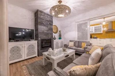 a living room with a couch and a tv at Riad Matias Galé - Luxury Villa with private pool, AC, free wifi, 5 min from the beach in Guia
