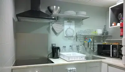 a kitchen with a sink and a counter top at Grey Heron Apartment in Quinta do Lago