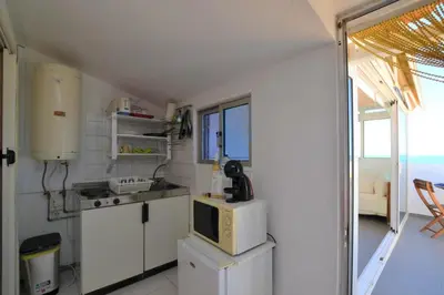 a bedroom with a bed and a ceiling fan at Ria Beach Studio in Faro