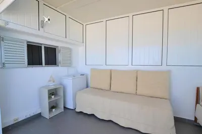 a balcony with a couch and a table and the ocean at Ria Beach Studio in Faro