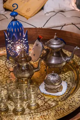 a table with a tea kettle and glasses on it at Villa Oasis Galé - Luxury Villa with private pool, AC, free wifi, 5 min from the beach in Albufeira