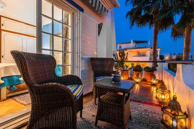 a patio with chairs and a table on a balcony at Villa Oasis Galé - Luxury Villa with private pool, AC, free wifi, 5 min from the beach in Albufeira