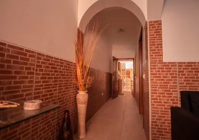 a hallway with a vase with a plant in it at ALGARVE TYPICAL DOWNTOWN HOUSE in Faro