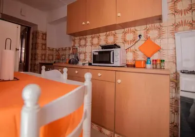 a kitchen with a microwave and a counter top at ALGARVE TYPICAL DOWNTOWN HOUSE in Faro