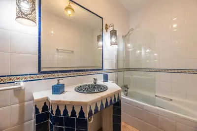 a bathroom with a sink and a mirror and a tub at Villa Galé Sun - Luxury, 5bed with free wifi, AC, private pool, 5 min from the beach in Guia