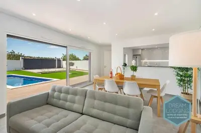 a living room with a couch and a dining table at Casa do Alto - Dream Lodging in Albufeira