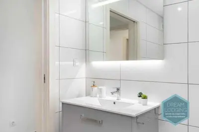 a white bathroom with a sink and a mirror at Casa do Alto - Dream Lodging in Albufeira