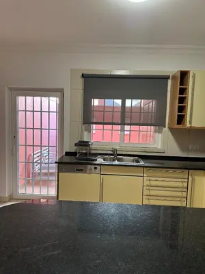 an empty kitchen with a sink and a window at V3 Vitória Boulevard in Vilamoura