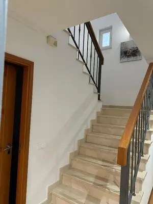a staircase in a house with wooden railings at V3 Vitória Boulevard in Vilamoura